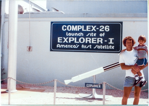 James MacLaren holds his son Kai in his arms, standing in front of the blockhouse at Complex 26, which was a part of the Air Force Space and Missile Museum, located at Cape Canaveral Air Force Station, Florida. Complex 26 is where America’s first satellite, Explorer 1, which was designed and built by the Jet Propulsion Laboratory, was lofted into orbit on top of a Juno 1 rocket, which was designed, built, and launched by a team led by Wernher von Braun, on January 31, 1958, marking America’s entry in to the Space Race with Russia during the Cold War, and the beginning of all subsequent orbital activities, programs, projects, and achievements which followed it. Photo by James MacLaren.
